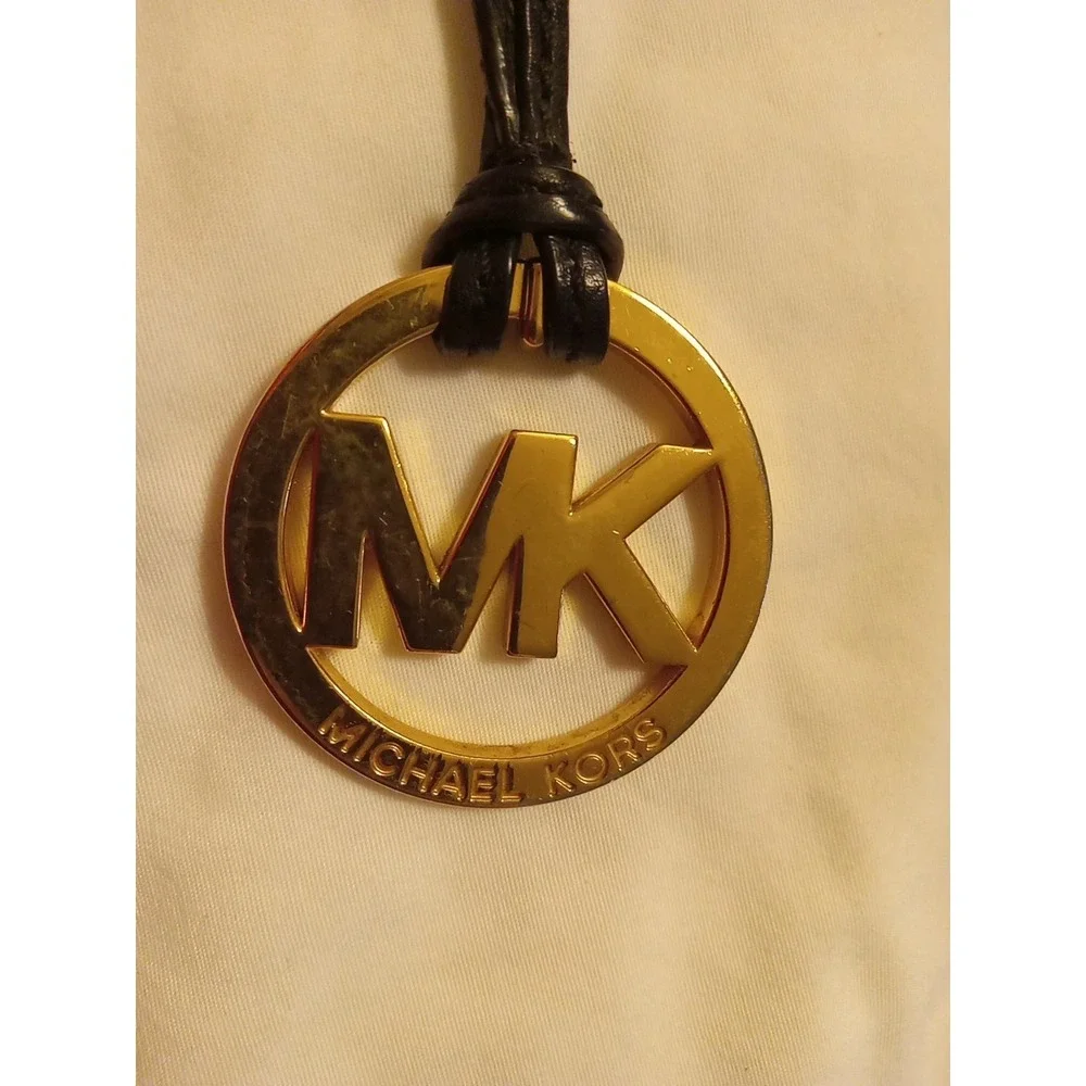 Michael Kors Gold Tone MK Logo Charm Hang Tag Luggage color Leather Strap